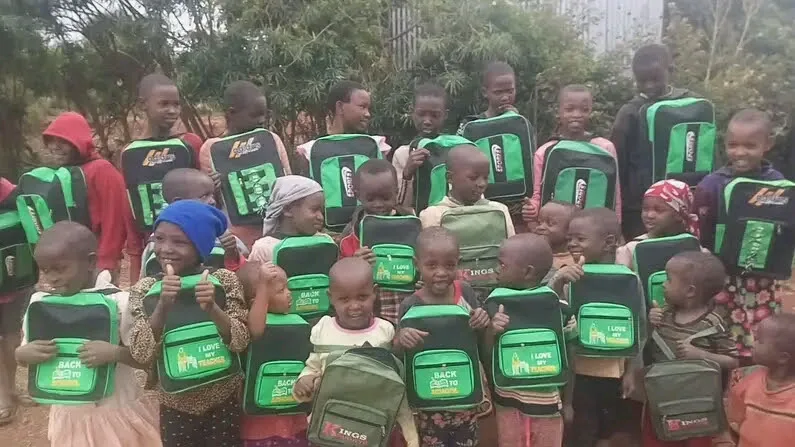 Pupils receiving school bags from OTEGA Foundation volunteers